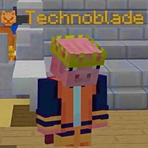 Technoblade in his orange ocelot skin in front of the Minecraft Championships steps, looking down at the ground